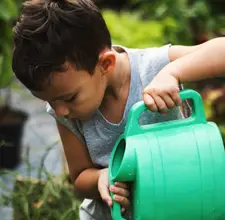 Elementary School Student Pouring Water - Five Pillars