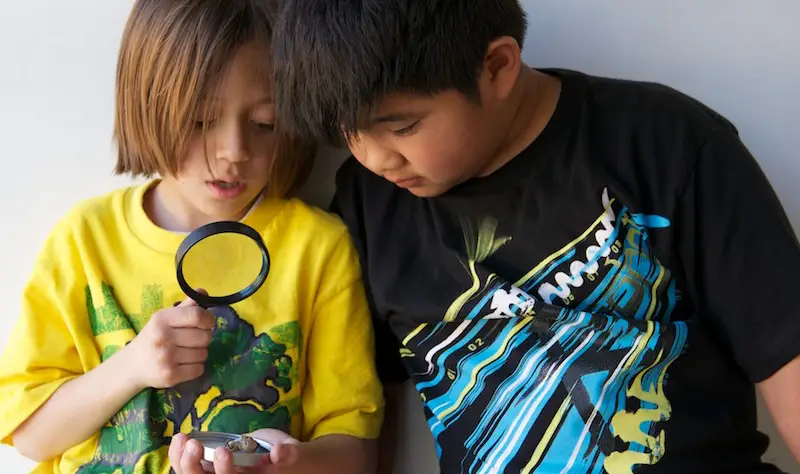 MUSE Global School Students With Magnifying Glass
